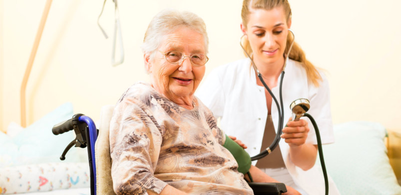 Young nurse and female senior in nursing home